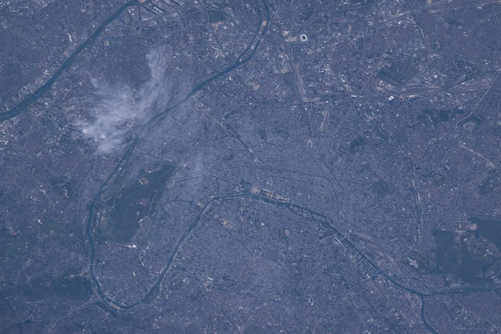 An aerial view of Paris, France, showing the Seine river winding through the city. The photographer titled it “Paris, France, split by the river Seine”.